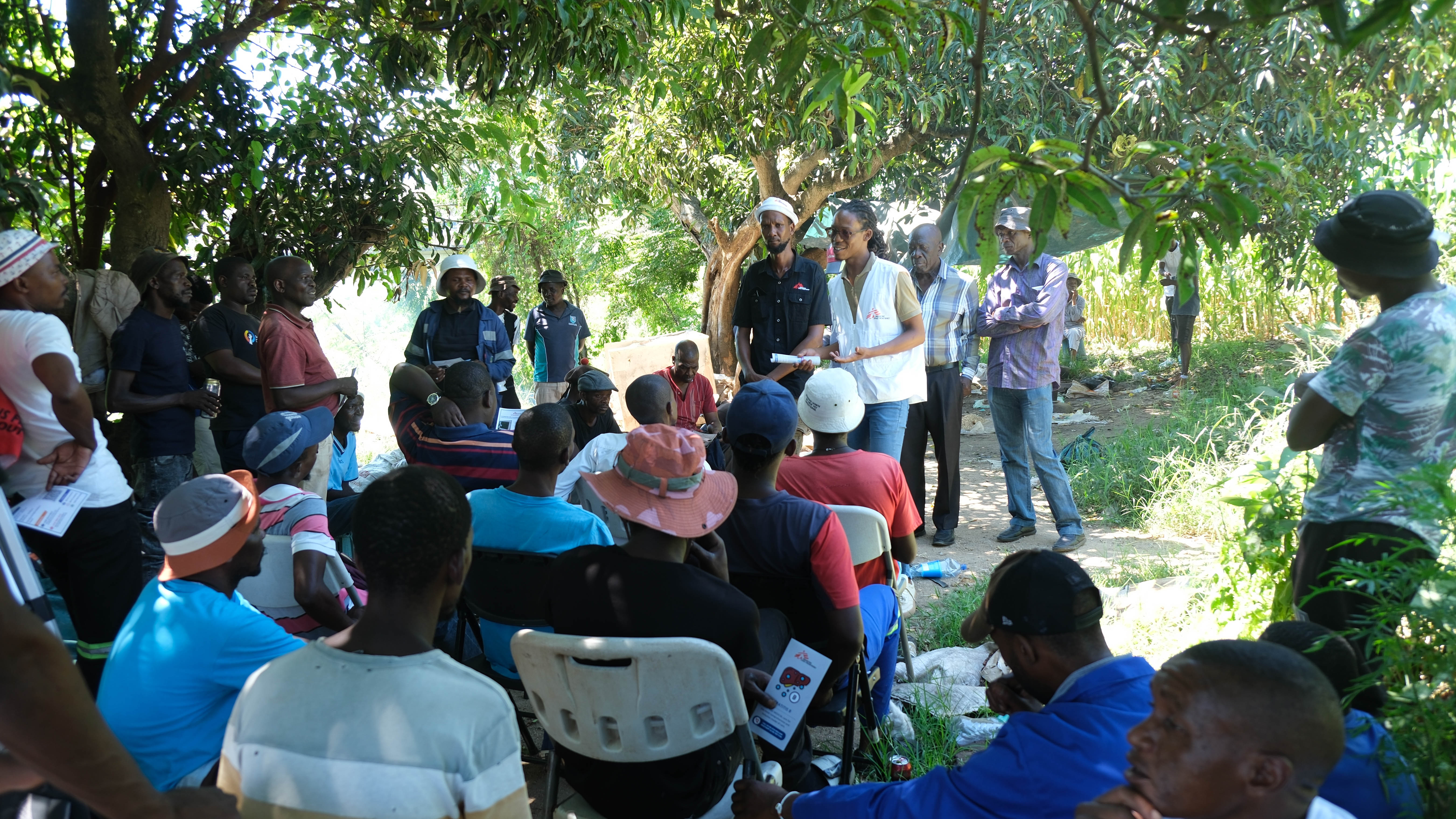 Community engagement with local leaders at a traditional "Cow Head" gathering named for the cow's-head meal shared with community elders, a mark of respect in the local custom, where our team promote information on improving access to care for survivors of sexual violence, followed by a shared meal with the community.