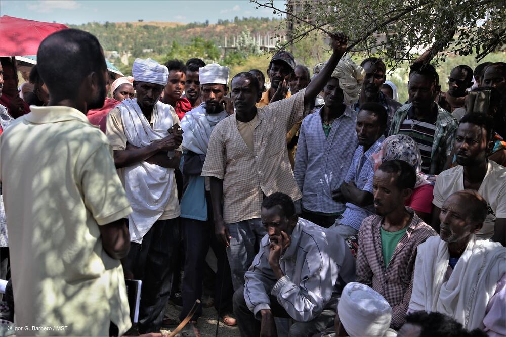 A group of displaced people engage in a discussion at Abdimalaha school in the city of Adwa, in central Tigray.