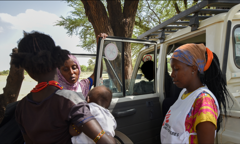 Zeitun Yussuf(centre) and Fiona Mutindwa (right) speak to a mother during an outreach in Illeret