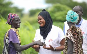 MSF Nurse Activity Manager for Abyei, Awa Abdumadou shares light moments with two community volunteers during a weekly visit to one of the 17 Integrated Community Case Management (ICCM) sites in Abyei