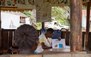 Sarah Aquila, Community Health Educator, sits with mothers before their antenatal care consultations in Jansuk Clinic, Yei County, Central Equatoria.