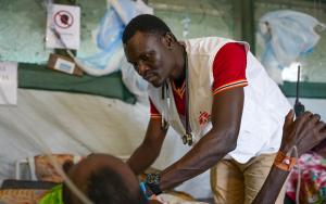 Dr Isaac Batali examines a patient