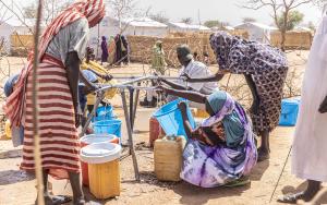 Women collecting water at a distribution point in Alacha camp, eastern Chad.