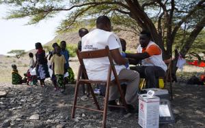 MSF team members vaccinating a child against measles at Napek village in Moite, Marsabit County.