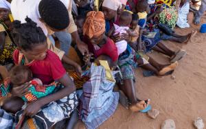 Andre Marcos, an MSF health promoter, assists with the triage of children in the waiting area at Micone temporary resettlement center in Chiure town, southern Cabo Delgado.