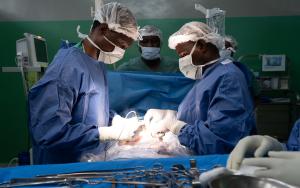 Surgeons at the Rutshuru General Reference Hospital cauterize a wound of a young gunshot victim.