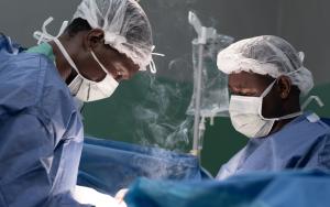 Surgeons at the Rutshuru General Reference Hospital cauterize a wound of a young gunshot victim.