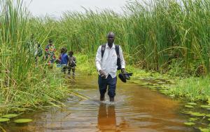 MSF paramedicine nurse Ghan Paul Hoth walks through floodwaters
