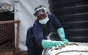 A hygiene worker disinfecting and cleaning the new cholera treatment centre to strengthen the outbreak response in South Kivu.