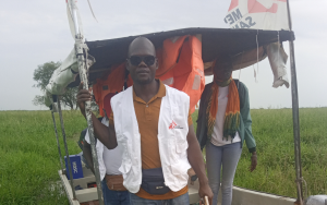 Getting out of the boat to walk to the community because the boat can not reach the docking point due to thick vegetation. 