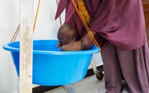 A mother places her son in a basin scale to be weighed in the emergency unit at the MSF-supported Bay Regional Hospital in Baidoa, Somalia. Basin scales are commonly used to weigh infants and young children as part of routine health screening.
