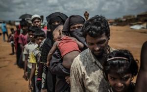 June 2018: A group of Rohingya refugees await assignment to their new homes in in the Kutupalong camp, Cox's Bazar. [© Pablo Tosco/Angular ]