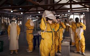 Health workers putting on their personal protective equipment (PPE) before entering in the red zone of the ETC in Butembo, DRC 