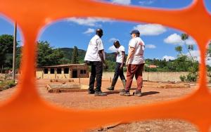 MSF staff discuss the plans for a 39-bed Ebola Treatment Centre in Mubende [© MSF/Sam Taylor] 