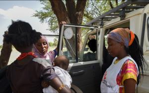 Zeitun Yussuf(centre) and Fiona Mutindwa (right) speak to a mother during an outreach in Illeret