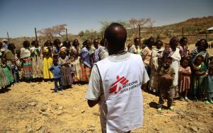 An MSF translator gives instructions to women waiting with their children for a medical consultation