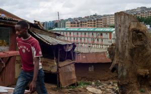 2014: A man walks past a small, tin-roof shop in the Kibera slum, near Kibera South Health Centre