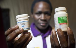 Catherine Atieno holds up her medication (2011) © Sven Torfinn