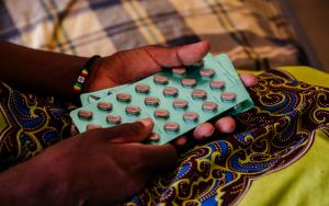 Ether, an advanced HIV patient in Malawi, with her medication in her hands