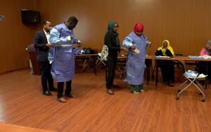 Sudanese healthcare professionals put on personal protection equipment during a training workshop 