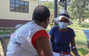 MSF nurse giving a training to a female MDR-TB patient in Matsanjeni health centre how to use Video 