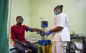 Faith Njeri, an EMT at MSF Lavender House checks vitals of a patient