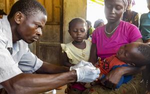 A community health worker carries out malaria test, Kenema 