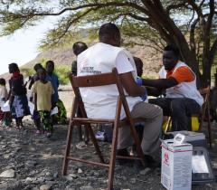 MSF team members vaccinating a child against measles at Napek village in Moite, Marsabit County.