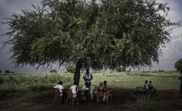 MSF team provides medical consultations to people at a temporary health post set up under a tree in Khadian, Abyei