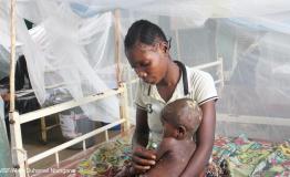 Mompondele Yangala, a 1-year-old child suffering from Mpox, in his mother's arms, hospitalised at the Bolomba general referral hospital, supported by MSF. His mother had also been treated for the disease.