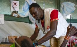 Dr Isaac Batali examines a patient