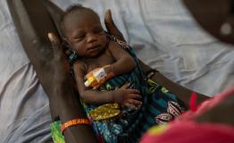 A mother holding a child