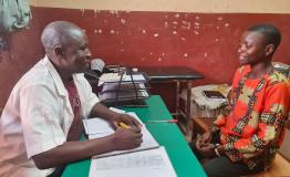 Adolphe Andao, 22, a type 1 diabetes patient, during a consultation with an MSF health worker at the chronic disease follow-up clinic in Carnot Hospital.