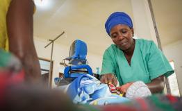 Nurse aide, Ndayumvire Antoinette attending to a child in the maternity ward at the MSF Hospital in Nduta Camp