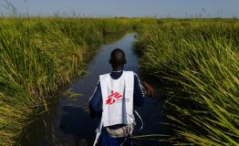 An MSF staff working in Kok island make his way back towards a MSF helicopter food drop in the troubled Unity State in South Sudan. 