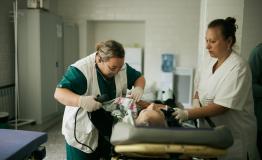 MSF staff are taking care of a 84 year old patient just admitted by ambulance at one of the hospitals in Mykolaiv region