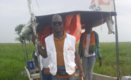 Getting out of the boat to walk to the community because the boat can not reach the docking point due to thick vegetation. 