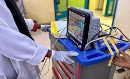 A medical staff is watching the monitor screen while checking a patient’s vital signs in the maternity ward of the hospital.
