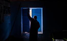Medical assistant Jaffer Sadiq Abaker Saleh, closes the shutters at a primary health care centre which is no longer fully functional due to funding cuts. Hamidya IDP camp, Zalingei.