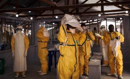 Health workers putting on their personal protective equipment (PPE) before entering in the red zone of the ETC in Butembo, DRC 