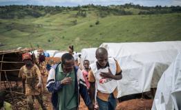 Nov 2019: Emmanuel Jilo (left) speaks to Djapan next to the place his shelter was destroyed in Rho