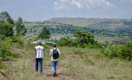 MSF staff walking in the field heading for a call-back during the NHIPS survey.