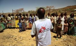 An MSF translator gives instructions to women waiting with their children for a medical consultation
