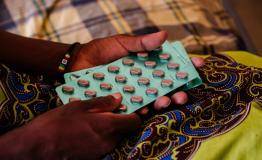 Ether, an advanced HIV patient in Malawi, with her medication in her hands