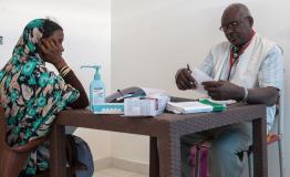 Nutrition assistant prepares a prescription for a woman in Al Kashafa 
