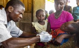 A community health worker carries out malaria test, Kenema 