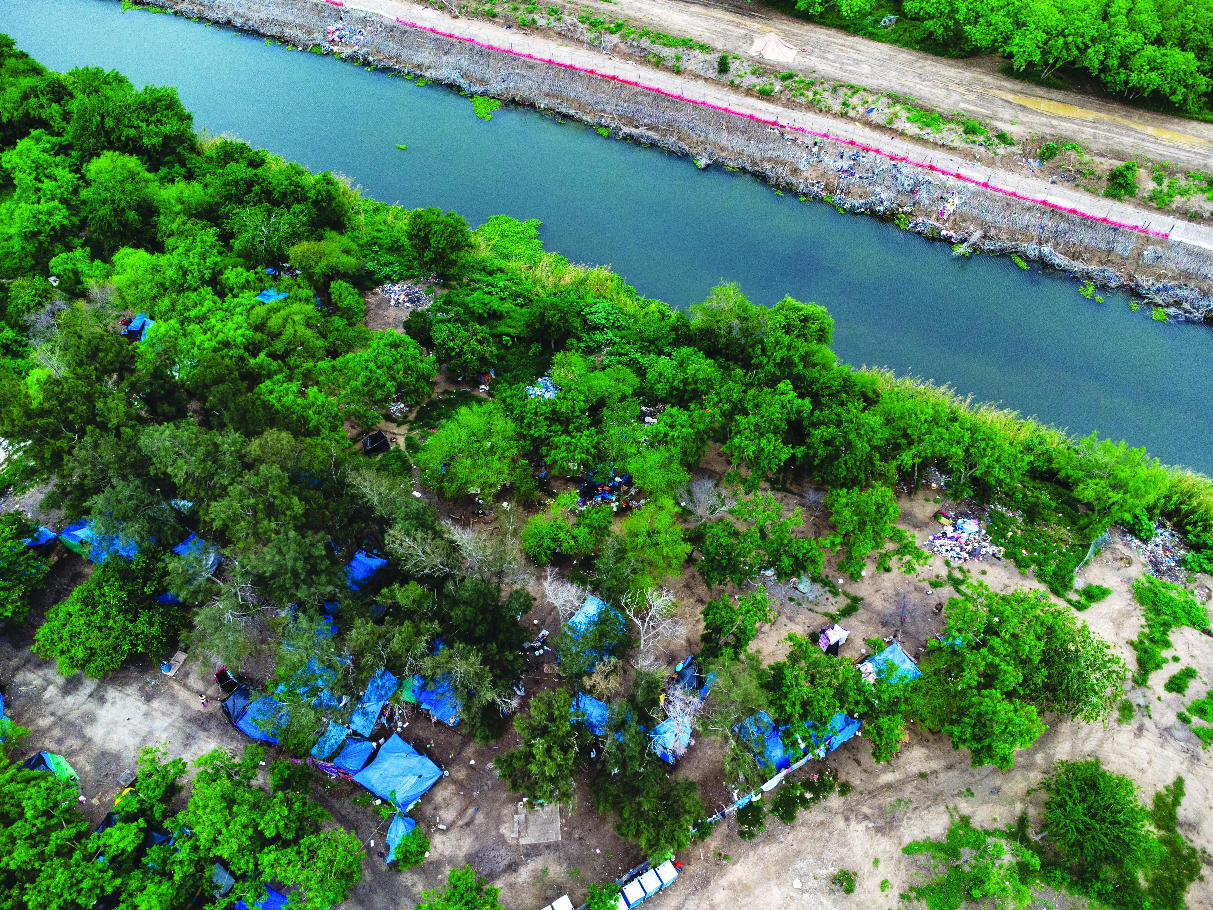 An aerial view of the migrant camp at the edge of the Rio Bravo that separates Tamaulipas, Mexico, from Texas, United States of America.
