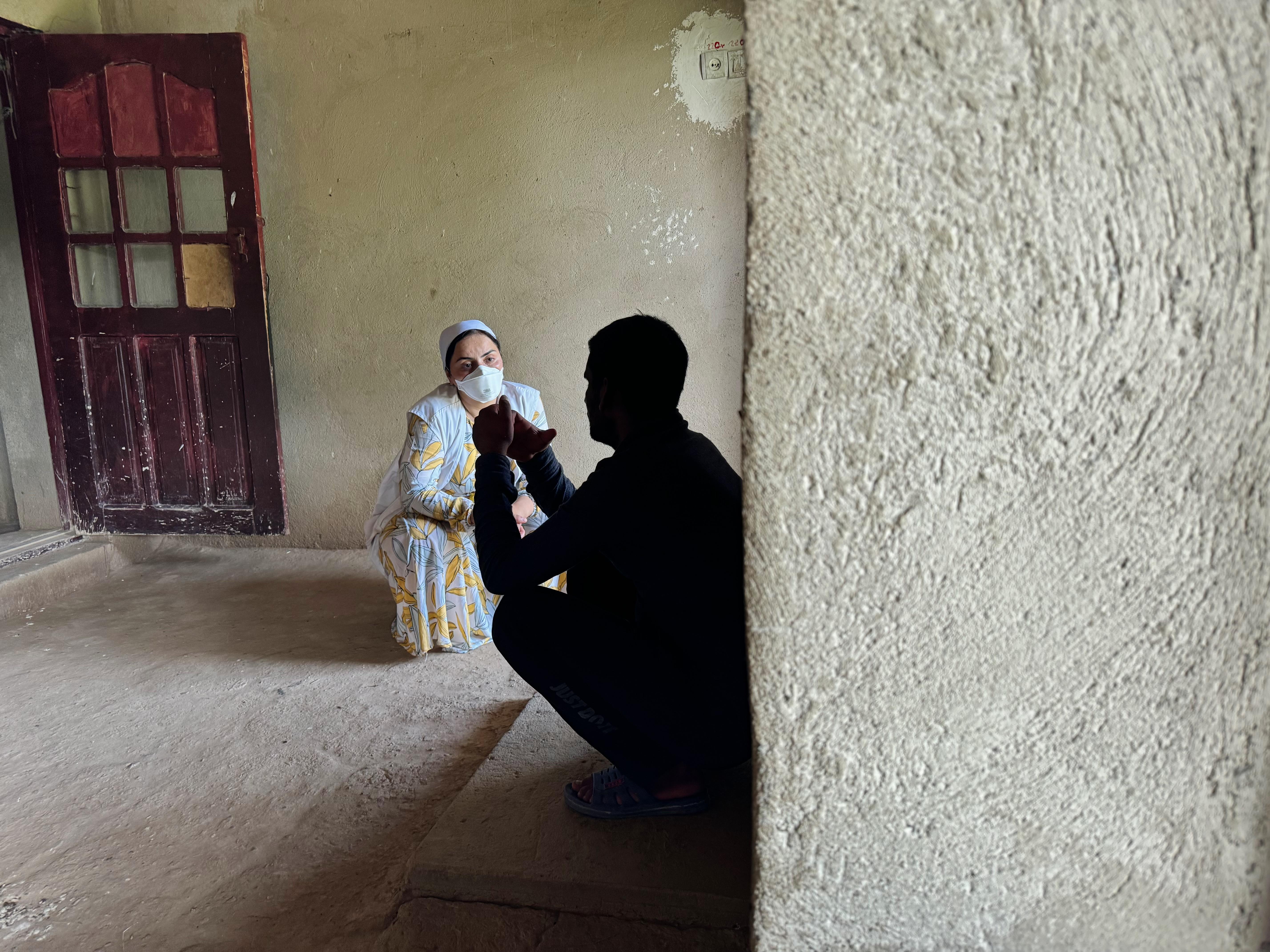 Munira Gulomova conducts a mental health consultation with Akmal Uganov, 25, at his home in the city of Tursunzoda, Tajikistan.