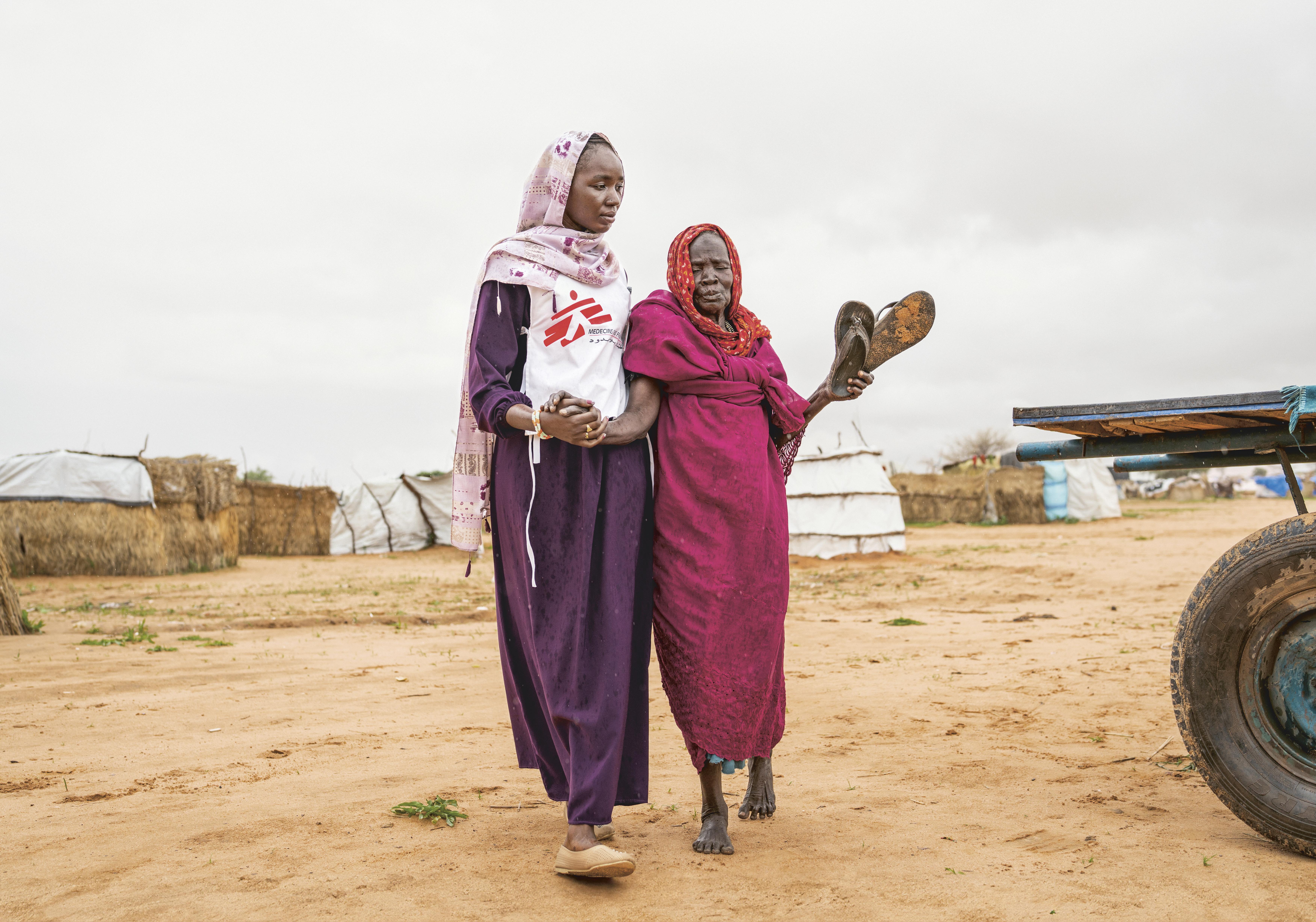 Aisha B., a health promoter, accompanies 80-year-old Aisha G.