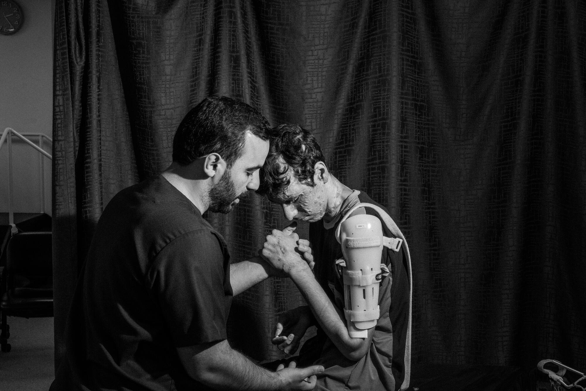 Karam, 17, from Nuseirat Camp in central Gaza, during a physiotherapy session at MSF's reconstructive surgery hospital in Amman, Jordan.